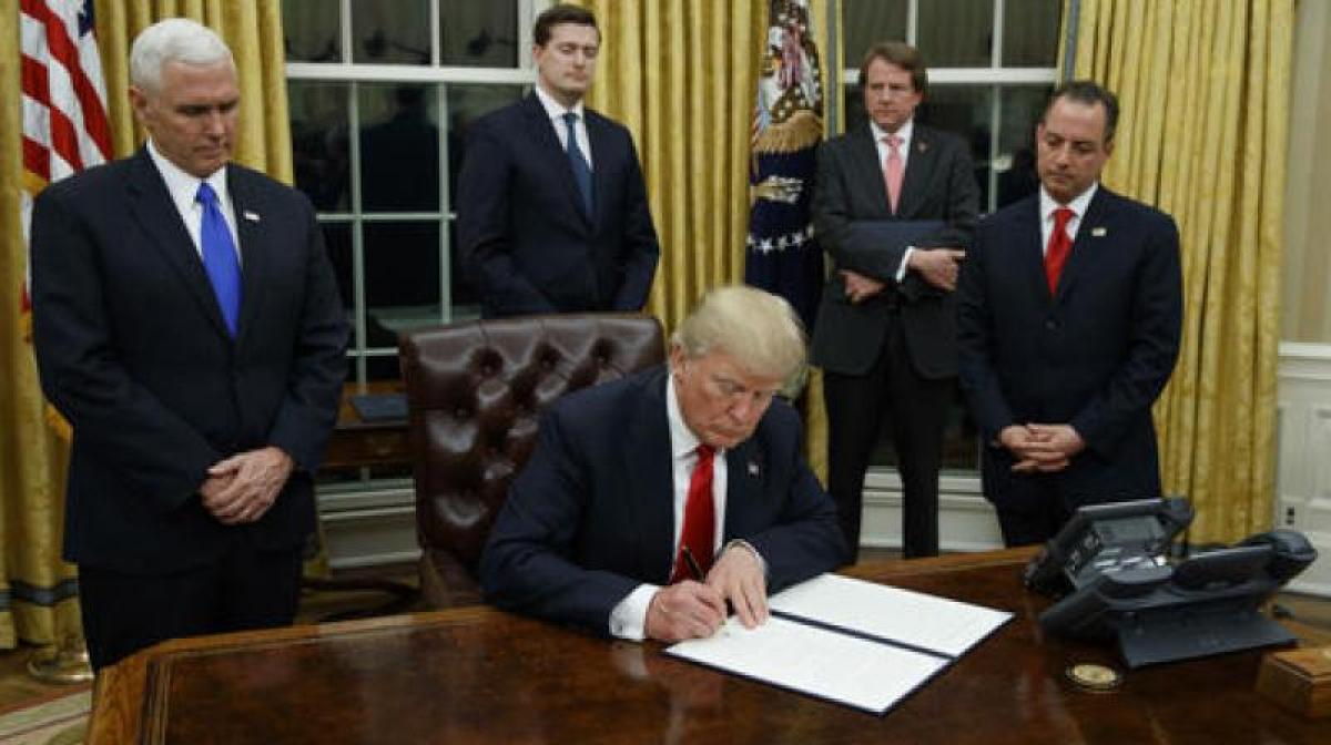 Trump signs executive order to ‘minimise burdens of Obamacare’
